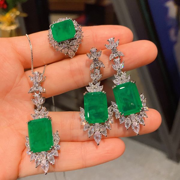 14K gold vintage emerald and diamond bridal jewelry set for women, including engagement rings, wedding bands, earrings, and necklace