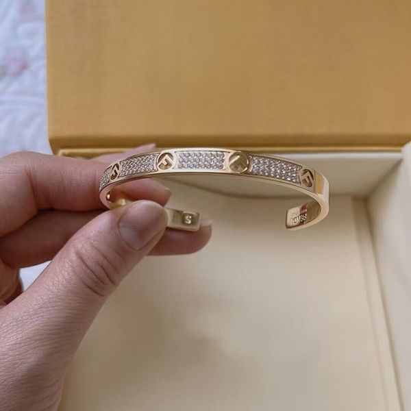 18k gold women's bangle bracelet with diamond accents, engraved letter logo, open design for weddings and gifts
