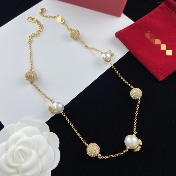 2023 stylish women's earrings featuring luxury gold heart-shaped studs with pearl and crystal accents, plus a double V letter necklace design