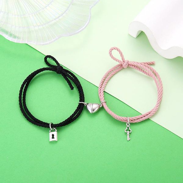 2-piece charm bracelets with magnetic locks for couples, featuring minimalist heart designs on braided rope wristbands for men and women
