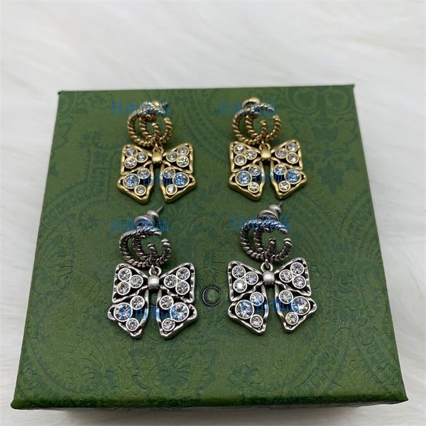 68% off stylish designer jewelry featuring ancient family letters, diamond-studded bow earrings for a chic, fashionable look