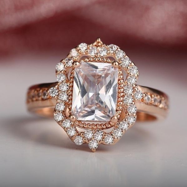 A luxurious 14K yellow gold ring featuring a 1.5-carat diamond, perfect for women's engagement or wedding, adorned with gemstones