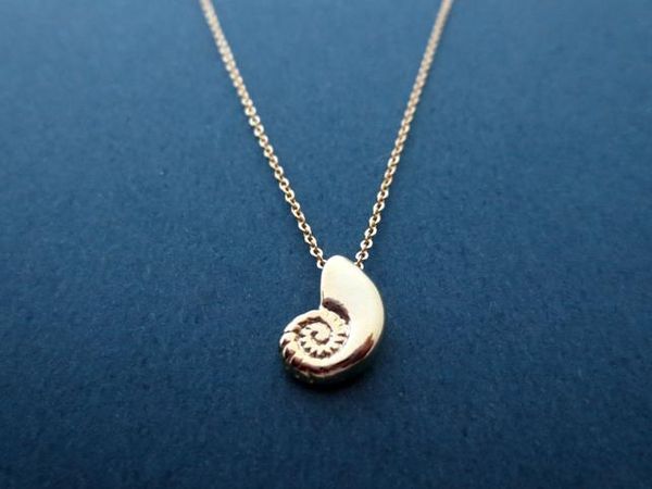 Adorable 3D seashell necklace featuring a conch shell design, inspired by the ocean and beach with a spiral swirl sea snail pendant charm