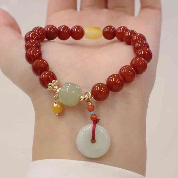 Bangle Bracelets featuring natural South Red Agate with a single ring emerald safety clasp and honey wax Hetian jade pendant