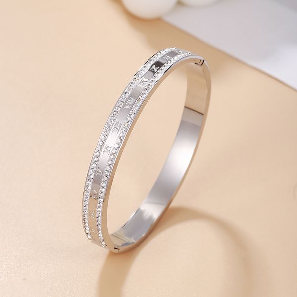 Beautiful stainless steel bangle bracelet with micro pave Roman numerals, perfect for gifting