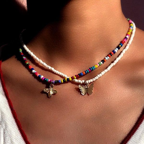 Boho pendant necklace featuring metal bee and butterfly charms with multicolored white beads, a stylish choker for women