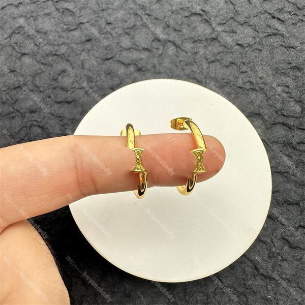 Brass gilded hoop earrings with diamond letter crystals and stud detailing