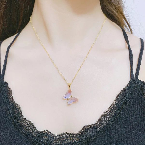 Butterfly 14k gold necklace for women featuring a pink and purple crystal pendant on a choker chain