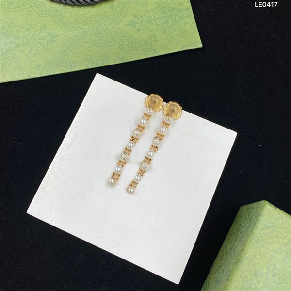 Chic lion head designer earrings for women featuring long pearl pendants, perfect for dates and parties, presented in a gift box