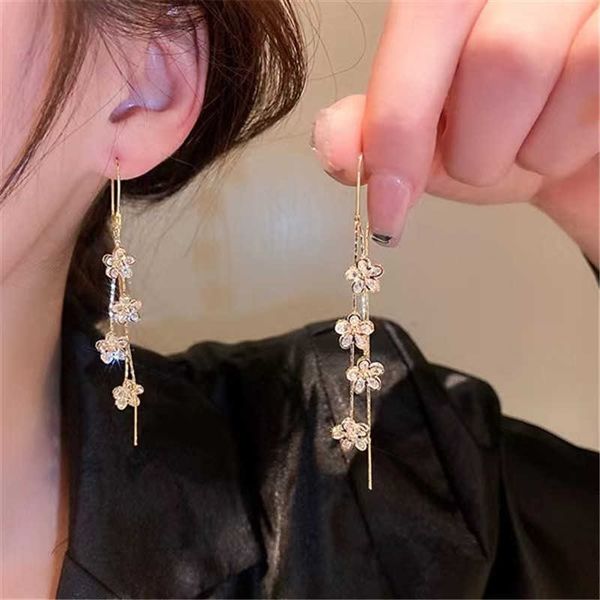 Chic minimalist long tassel earrings featuring delicate floral zircon pendants on elegant wire hooks, perfect for parties and gifting