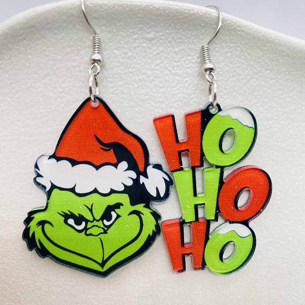 Christmas-themed acrylic earrings featuring playful asymmetric designs with Xmas trees, HOHOHO letters, stars, snowmen, snowflakes, Grinch, and Santa Claus charms