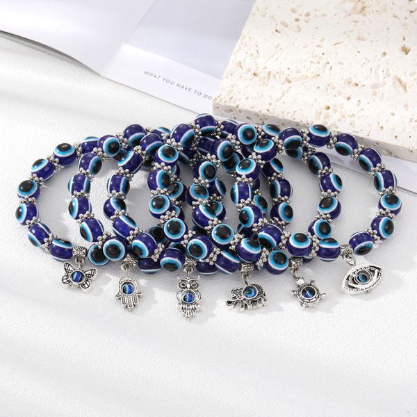 Classic animal charm bracelet with 10mm blue evil eye beads, perfect as a gift