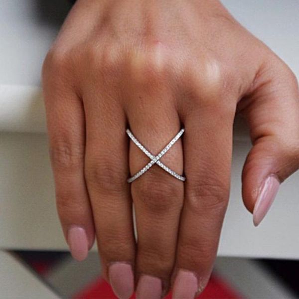 Cluster rings featuring cross-ring plating with solid zircon crystal pave in clear stacking stones, available in sizes 6 through 9