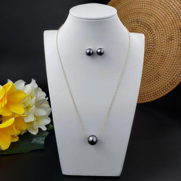 Dainty black Tahiti pearl earrings set with a floating round pearl, handmade in Hawaii for bridesmaids and Polynesian jewelry lovers