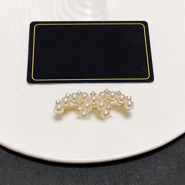 Designer brooch with gold plating, featuring pearls and diamonds in a love-themed design, ideal for weddings and parties as a stylish gift