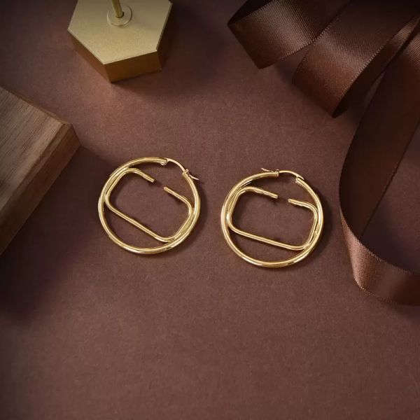 Designer gold hoop earrings for women and men, stylish circle letter jewelry with luxury couple V studs