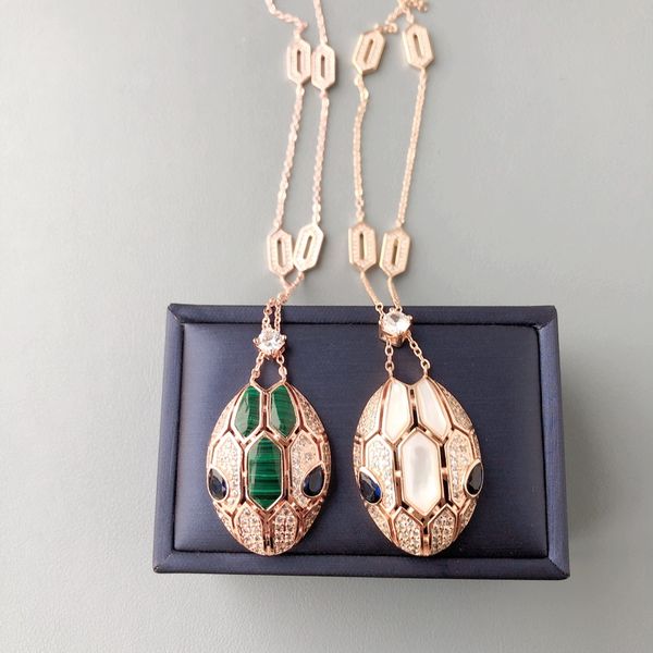 Designer pendant necklaces for women featuring diamond, mother of pearl, and malachite accents in gold plating with blue snake head motifs