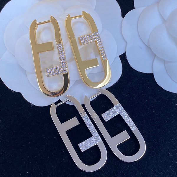 Designer silver stud earrings with gold letters, stylish luxury jewelry for women and men, fashionable hoop earrings