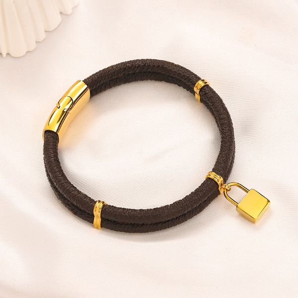 Designer women's gold curb bracelet with lock pendant, crafted from vintage-style leather and stainless steel for a stylish jewelry gift