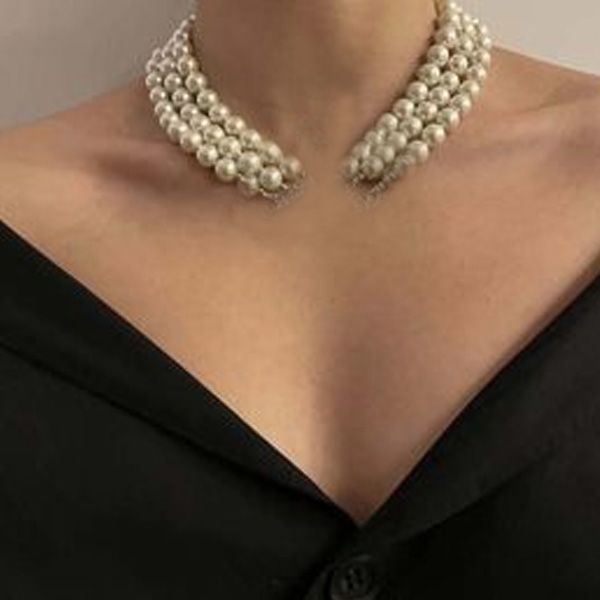 Designer women's necklace featuring layered pearls, rhinestones, and baroque pearls in an elegant orbit clavicle chain