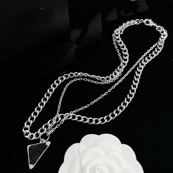 Double chain isosceles triangle pendant necklaces for men and women, featuring an inverted triangle letter design on a stylish clavicle chain