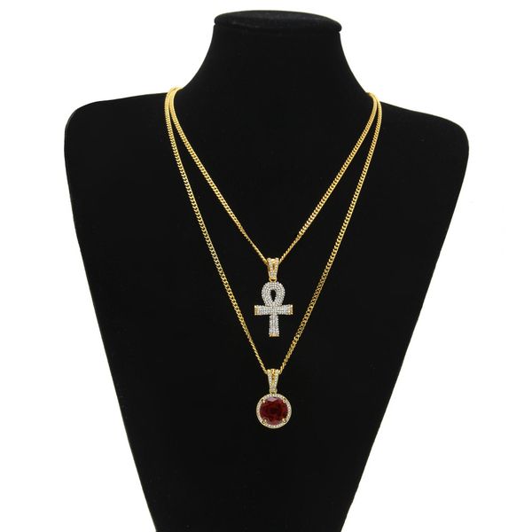 Egyptian-inspired large Ankh pendant necklace sets featuring round ruby and sapphire accents with rhinestone details, paired with cross charms and Cuban link chains for stylish men's hip hop jewelry