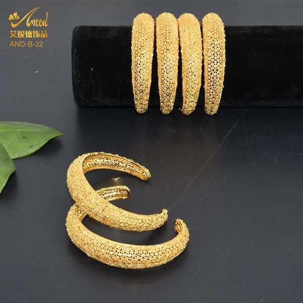 Elegant 18K gold bangles with designer charms, perfect for weddings in Dubai, African, and Turkish styles