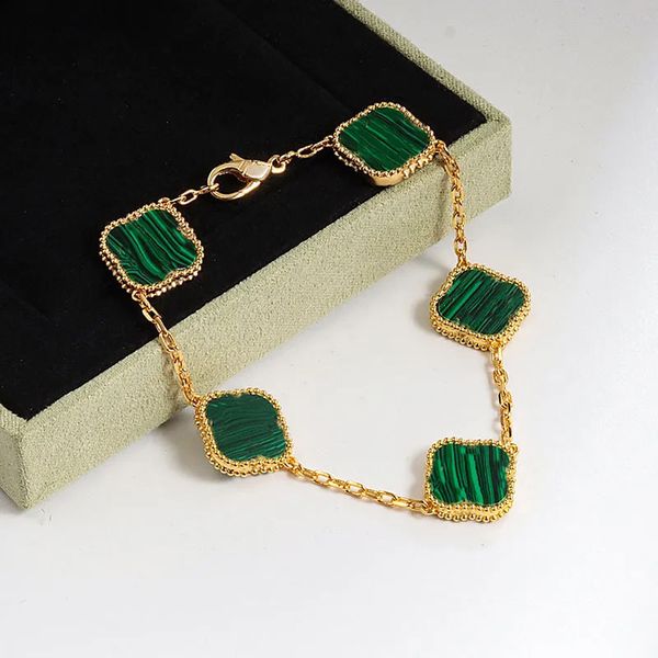 Elegant 18K gold bracelet featuring four-leaf clover charms with onyx and mother-of-pearl accents, perfect for women and girls' weddings and Mother's Day