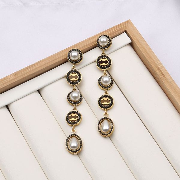 Elegant 18K gold-plated designer stud earrings featuring double long pearl pendants, perfect for weddings, parties, or as gifts in 13 stylish designs