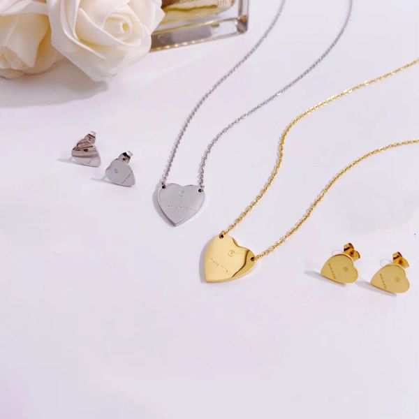 Elegant designer pendant necklace set for women featuring 18K gold-plated titanium steel with heart-shaped G letter charm and matching earrings