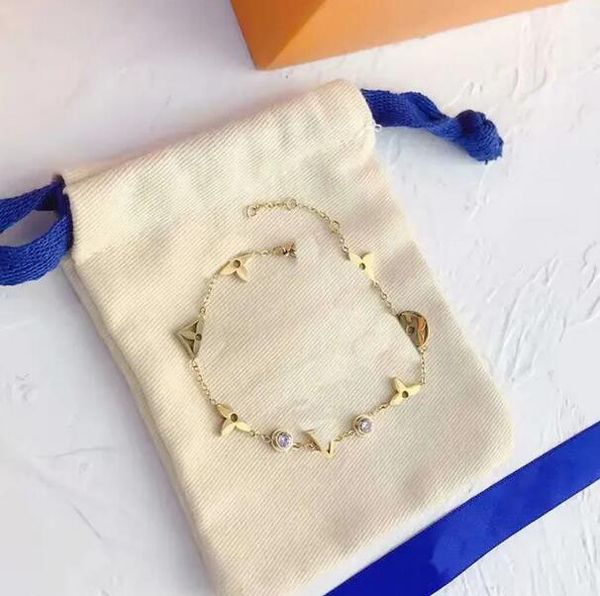 Elegant diamond charm bracelet for women featuring floral and heart designs in gold-plated stainless steel