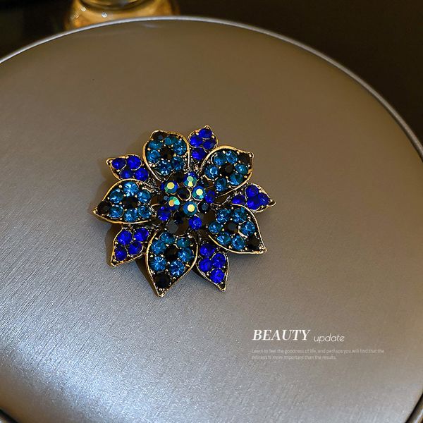 Elegant diamond-embellished floral brooch for stylish winter outfits