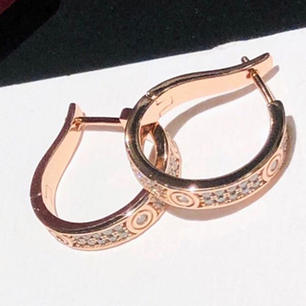Elegant diamond-studded 18K gold-plated silver earrings for women, featuring designer charms in classic luxury style