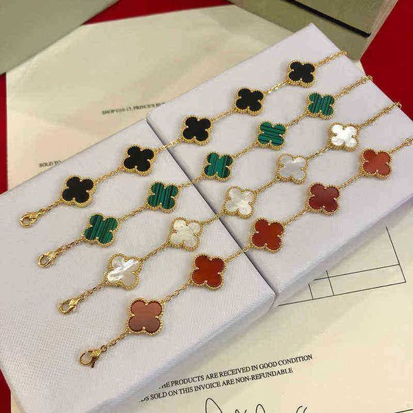 Elegant four-leaf clover charm bracelet for women, crafted in 18k gold with agate, shell, and mother-of-pearl accents, perfect for weddings and Mother's Day gifts