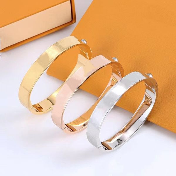 Elegant gold designer bangles for women and men, crafted in stainless steel with couple charms and floral patterns, perfect for parties and gifts