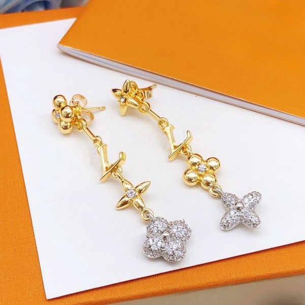 Elegant gold diamond earrings for women, perfect for parties and weddings, presented in a stylish box
