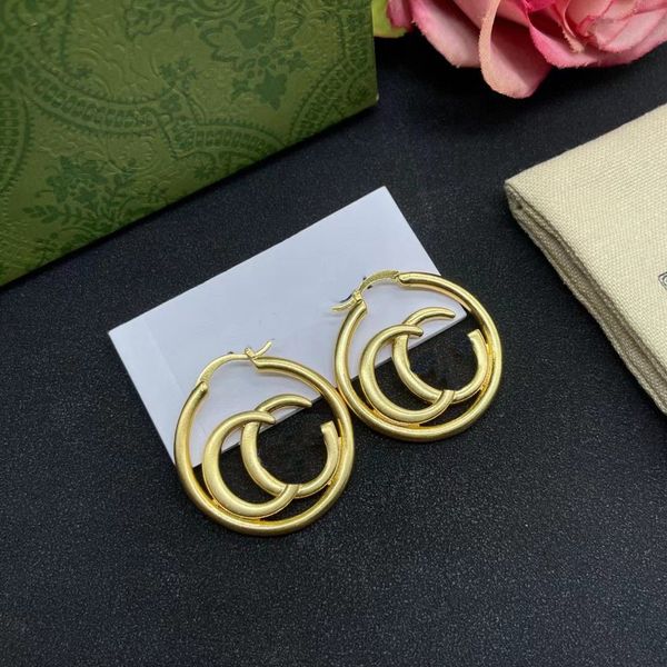 Elegant gold hoop earrings for women featuring stylish letter studs, presented in a chic gift box ideal for parties and romantic dates