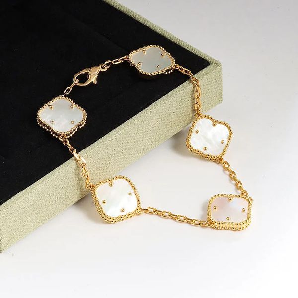 Elegant gold-plated bracelet featuring mother of pearl and clover flower charms