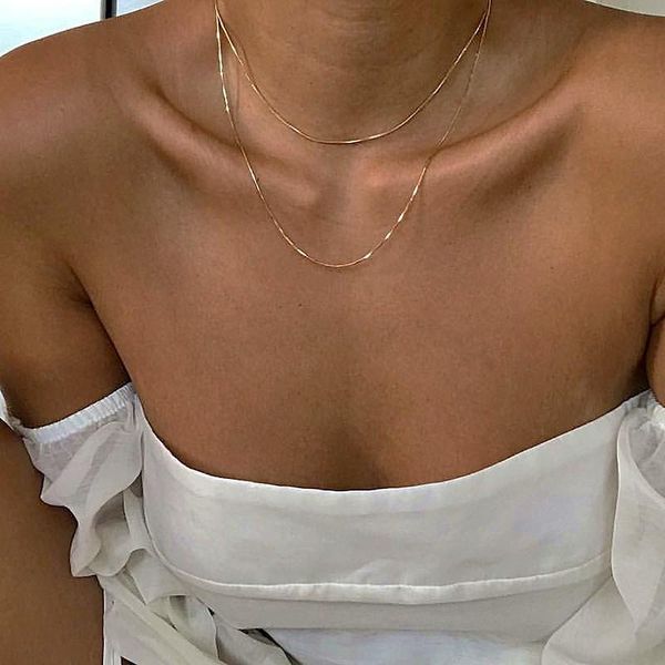 Elegant gold-tone snake bone chain necklace for women, a stylish layered choker perfect for parties and fashion accessories