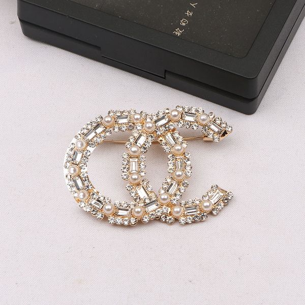 Elegant inlaid pearl brooch for women with diamond accents in gold/silver tones, a trendy Christmas gift choice
