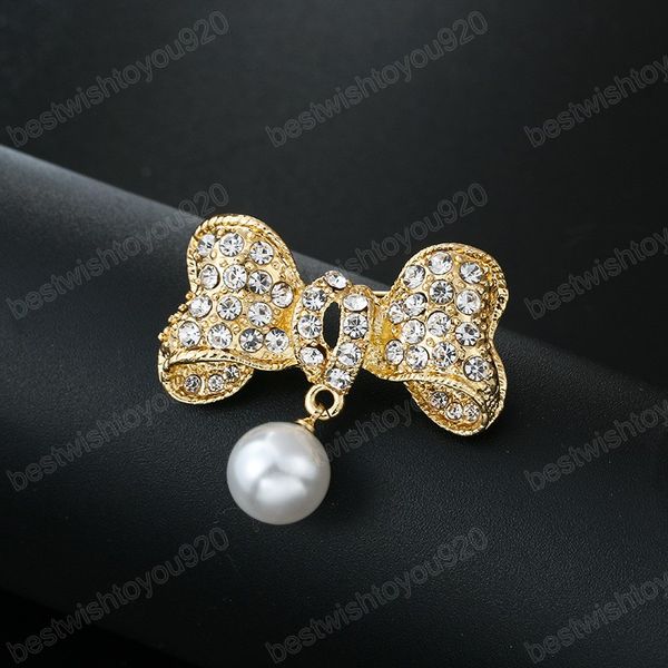 Elegant metal bow brooch adorned with rhinestones and pearls, perfect for women's dresses, suits, coats, or as a wedding corsage jewelry gift