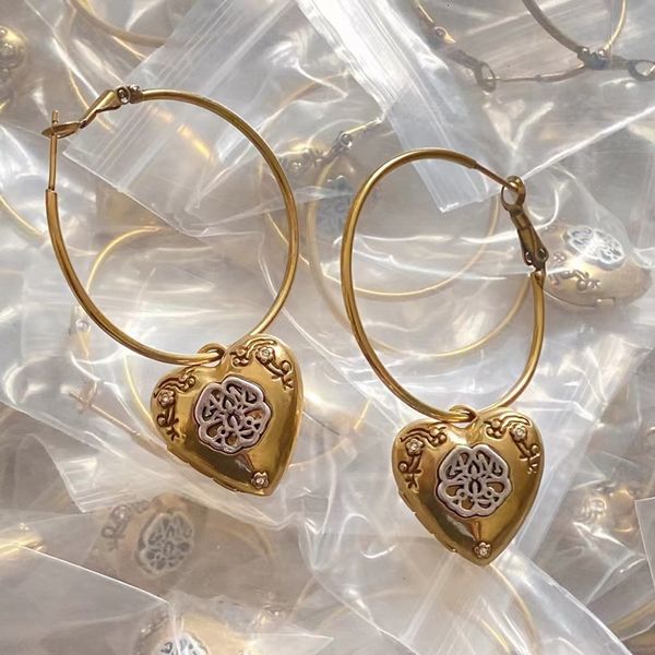Elegant personalized earrings featuring asymmetric tassel design with circle love motif and red diamond accents in S925 silver