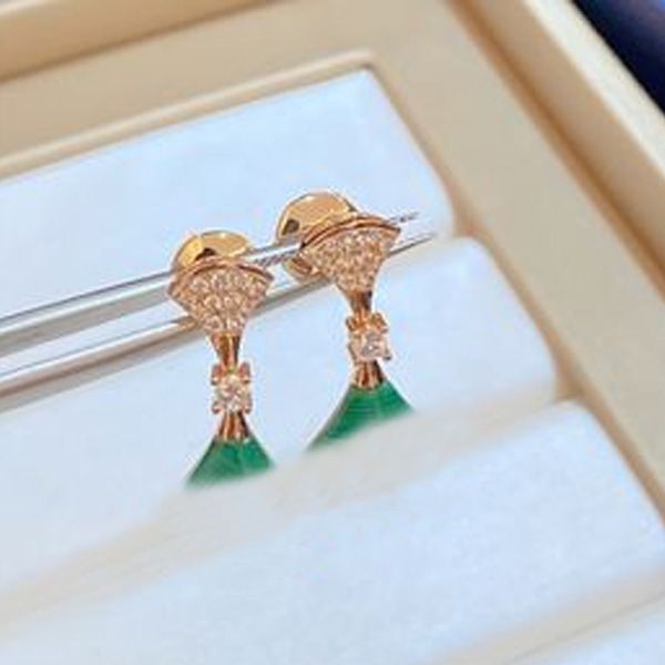 Elegant scalloped mother-of-pearl earrings from a luxury designer, perfect for stylish weddings and high-quality jewelry that won't fade
