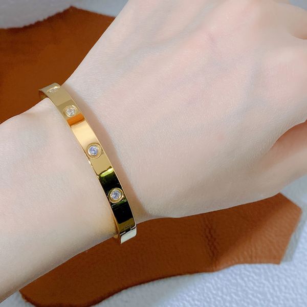 Elegant screw-design bangles in 18K rose gold, silver, titanium or steel with diamond accents, a luxurious jewelry collection