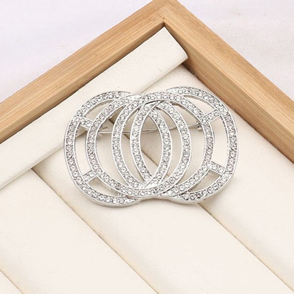 Elegant semicircular brooch featuring pearl and crystal inlays with a cross or letter design, perfect for women's fashion accessories and suit jewelry