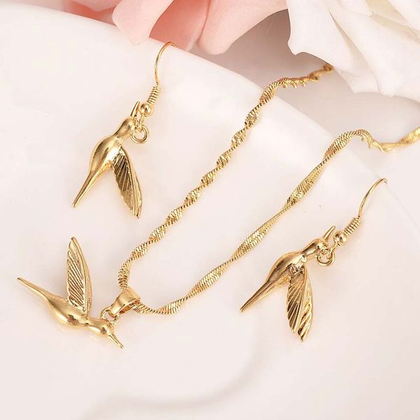 Elegant solid yellow gold hummingbird pendant earrings with delicate Tobago bird design, perfect as necklace charms for women