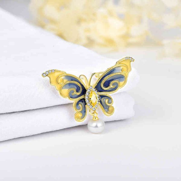 Elegant winter butterfly brooch with high-quality enamel, natural pearls, and a stylish sweater chain pendant for women