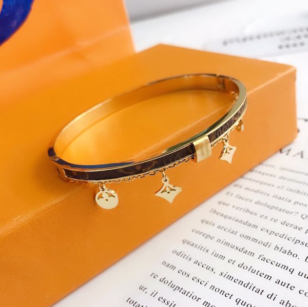 Elegant women's bangle bracelet featuring designer letters, crafted from faux leather with 18K gold-plated stainless steel for a stylish wrist accessory