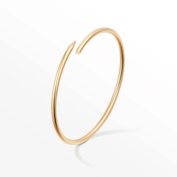 Elegant women's designer bangle bracelets crafted from titanium steel alloy with gold plating, presented in a gift box and bag