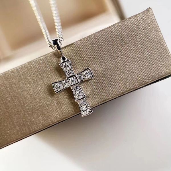 Elegant women's designer pendant necklace featuring a stylish snake bone cross chain, perfect for party-loving girls and women with hypoallergenic properties